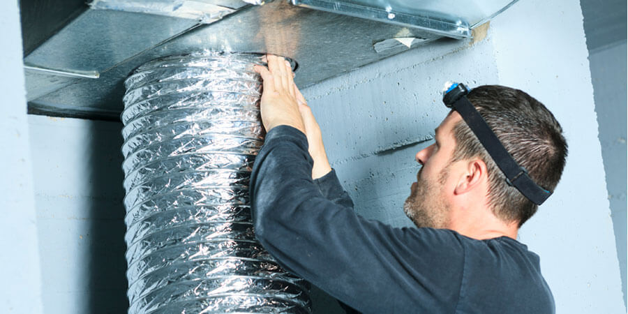 Technician installing duct 