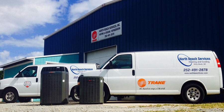 North Beach Services Heating and Cooling service trucks with Trane units in front of building