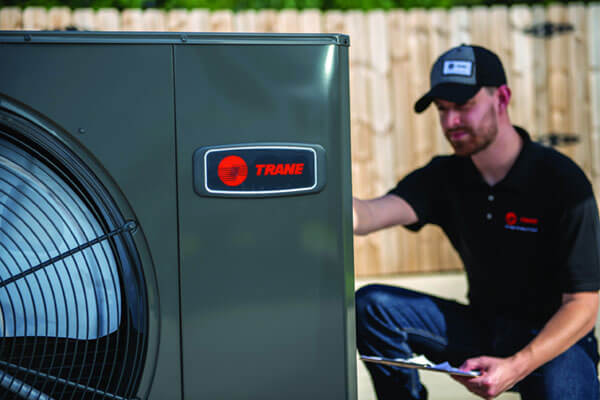 Trane unit and technician in the background